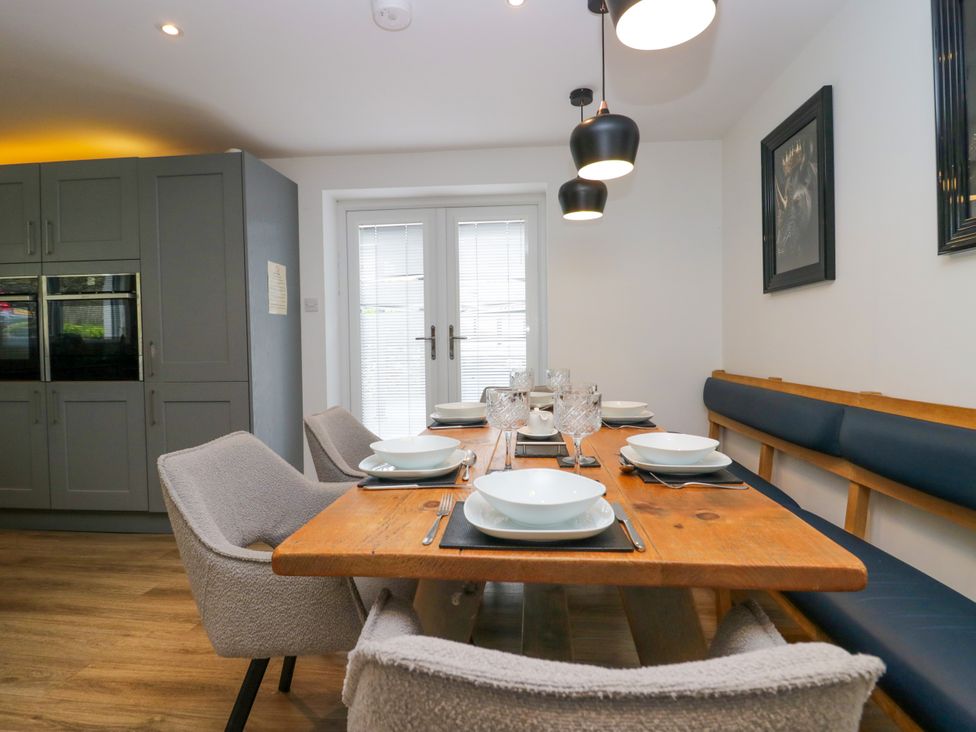 A dining room with a wooden table and chairs at 10 Rayrigg Rise Bowness-On-Windermere