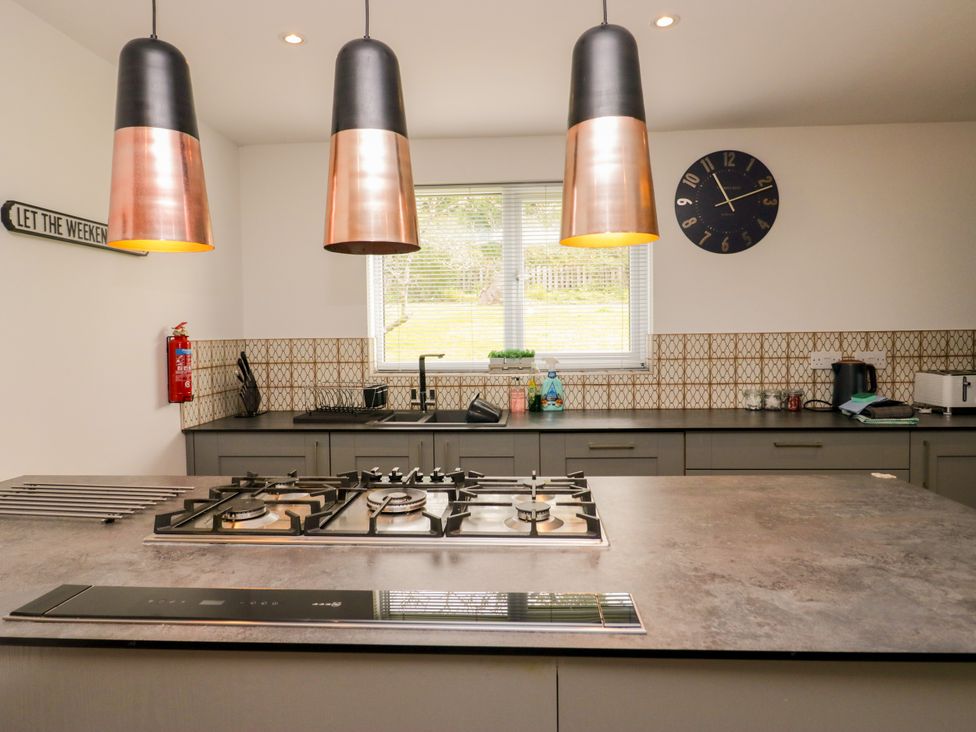 A kitchen with gas stove and kitchen sink at 10 Rayrigg Rise Bowness-On-Windermere