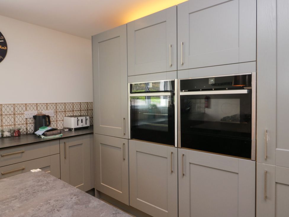 A kitchen with built-in ovens and appliances at 10 Rayrigg Rise Bowness-On-Windermere