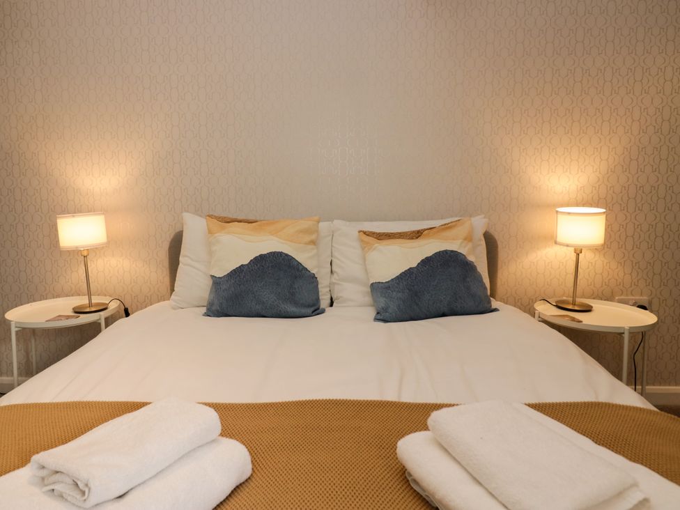 A bedroom with bed and bedside tables at 10 Rayrigg Rise Bowness-On-Windermere
