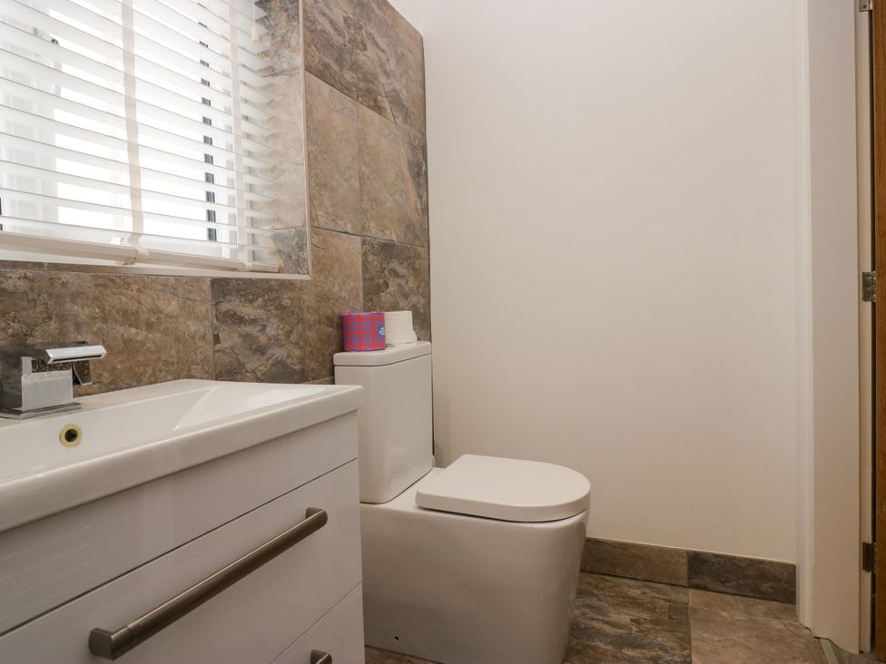 A bathroom with a toilet and sink at 10 Rayrigg Rise in Bowness-On-Windermere