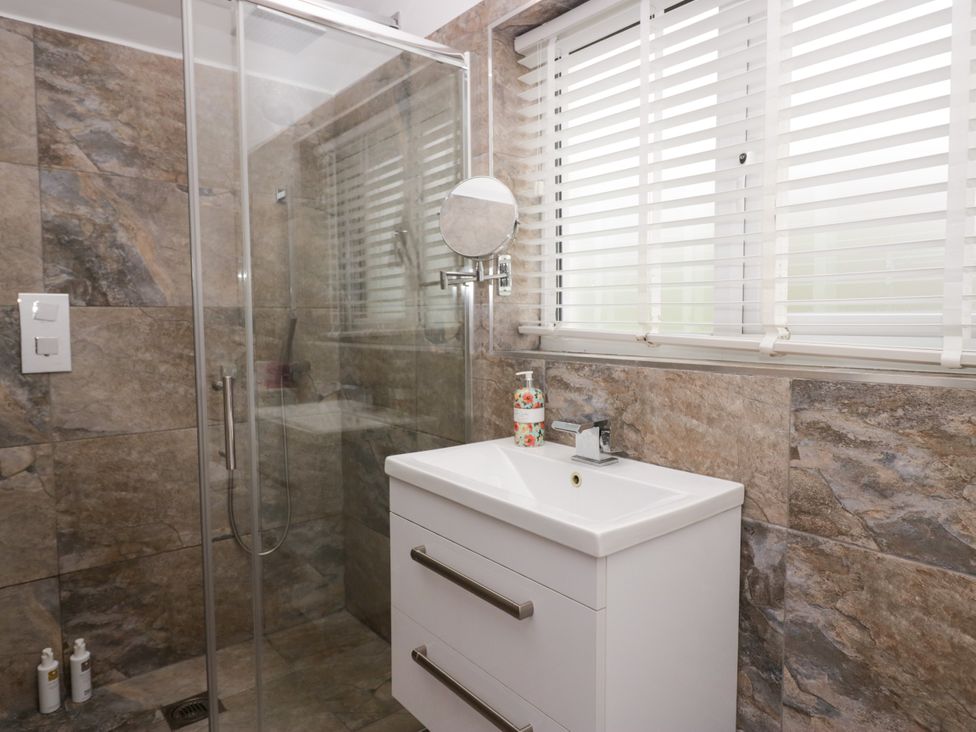 A bathroom with a shower and sink at 10 Rayrigg Rise Bowness-On-Windermere