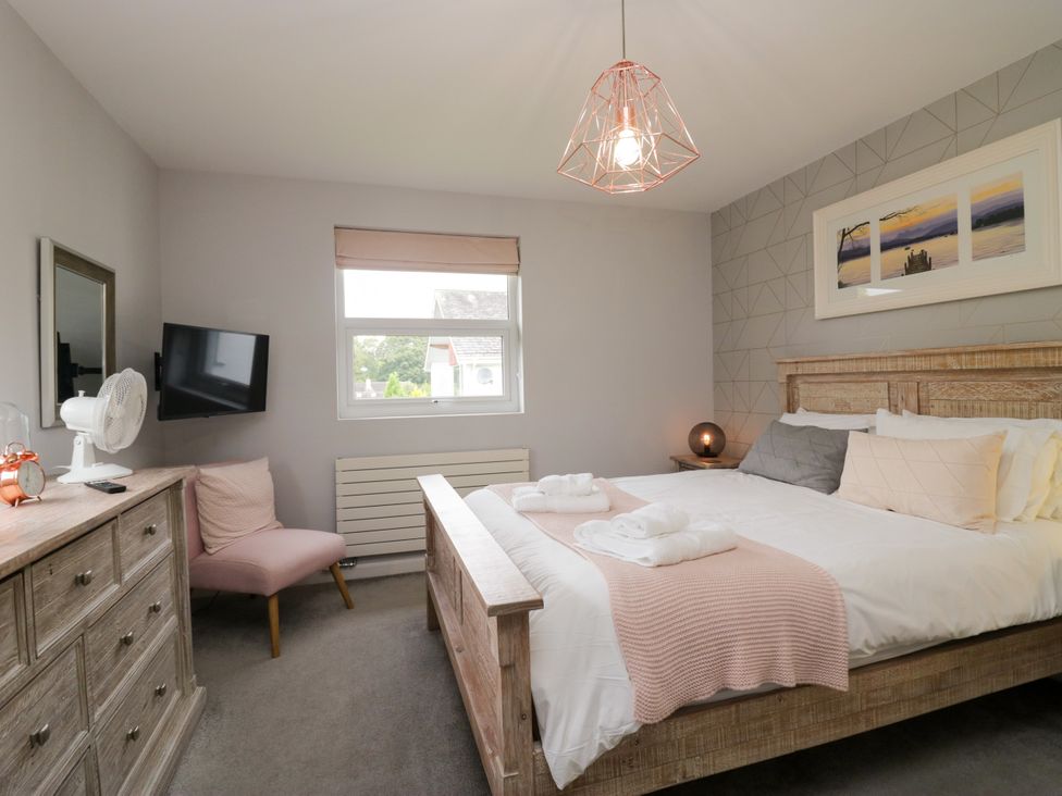 A bedroom with a bed and dresser at 10 Rayrigg Rise Bowness-On-Windermere