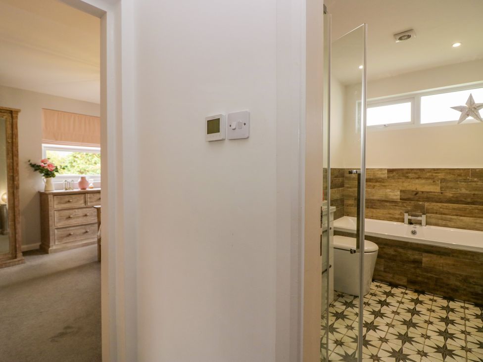 A bathroom featuring a bath, toilet, and sink at 10 Rayrigg Rise in Bowness-On-Windermere