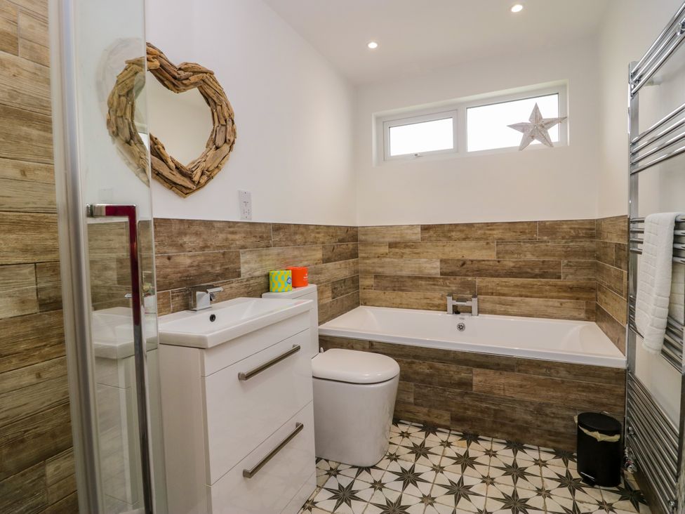 A bathroom with a sink and bathtub at 10 Rayrigg Rise Bowness-On-Windermere