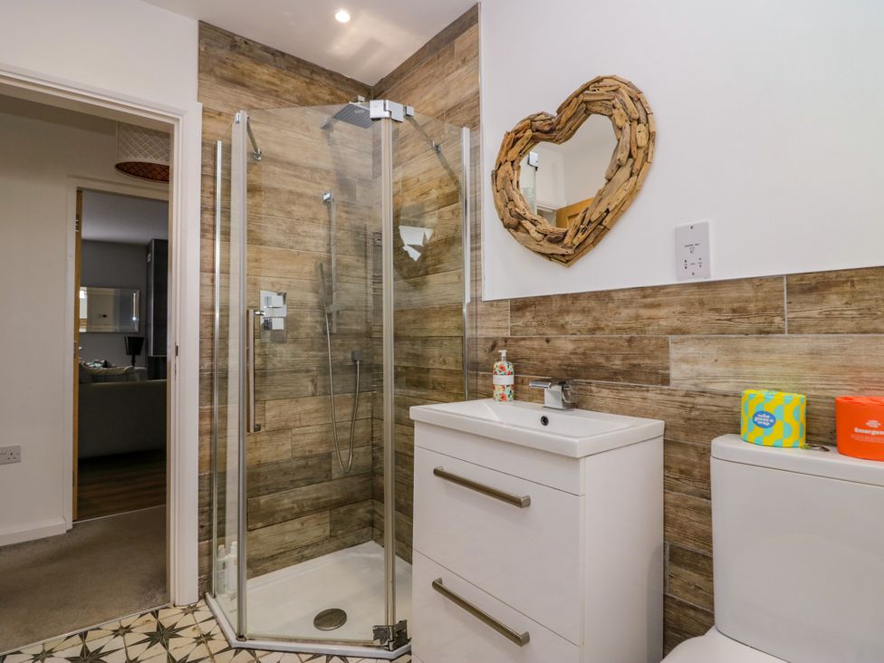 A bathroom with shower, sink, and toilet at 10 Rayrigg Rise Bowness-On-Windermere