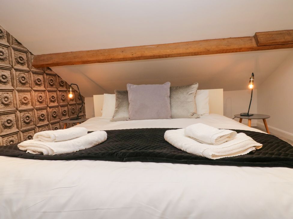 A bedroom with a bed and pillows at 10 Rayrigg Rise Bowness-On-Windermere