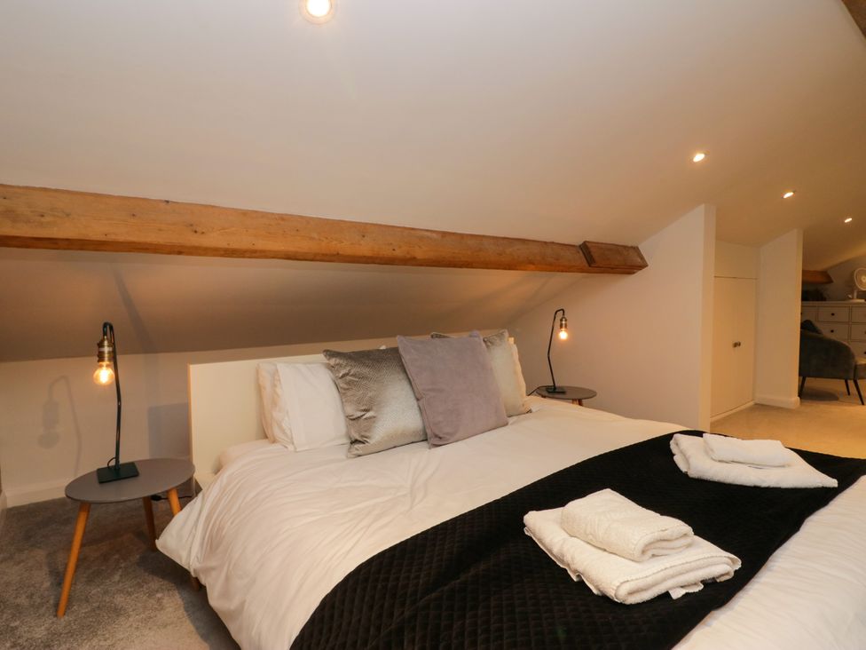 A bedroom with a bed and bedside table at 10 Rayrigg Rise Bowness-On-Windermere