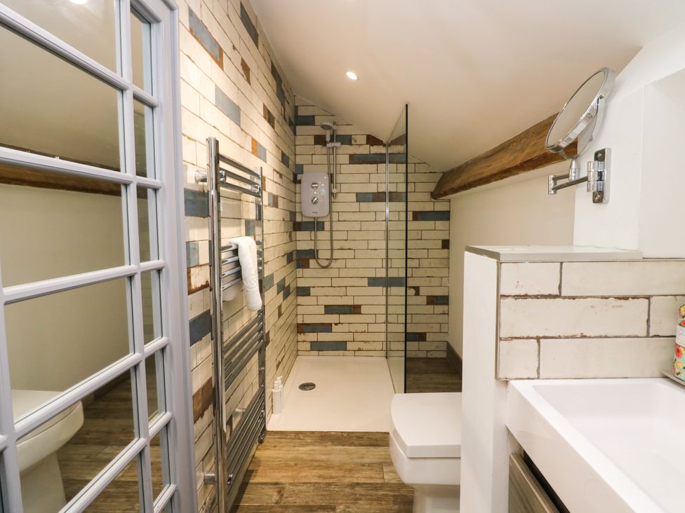 A bathroom with shower, toilet, and sink at 10 Rayrigg Rise Bowness-On-Windermere