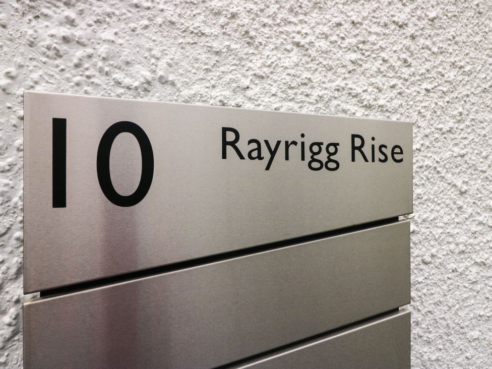 A metal sign displaying the number 10 and Rayrigg Rise