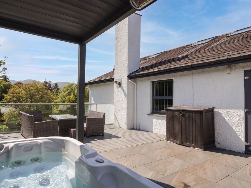 An outdoor area with a hot tub and seating at 10 Rayrigg Rise Bowness-On-Windermere