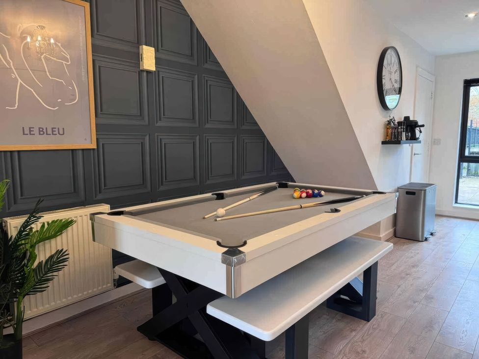 A game room with a pool table and clock at 11 Radclyffe Mews, Salford