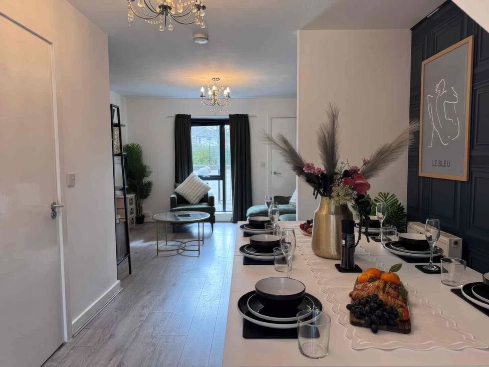 A dining area with a table set for a meal at 11 Radclyffe Mews Salford