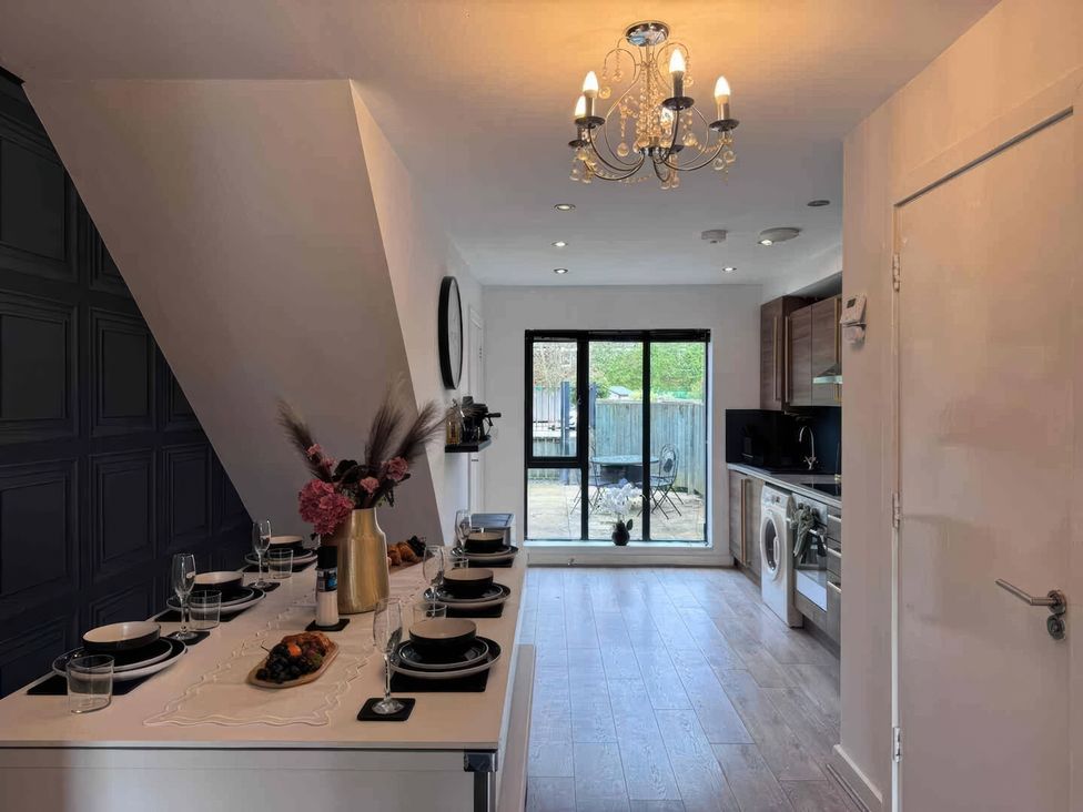 A kitchen with a dining table and chairs at 11 Radclyffe Mews Salford