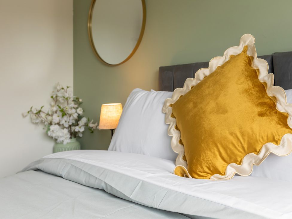 A bedroom with a bed and decorative elements at 11 Radclyffe Mews in Salford