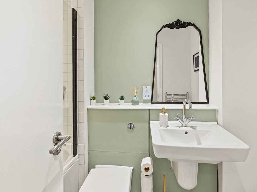 A bathroom with a sink, toilet, and shower at 11 Radclyffe Mews in Salford