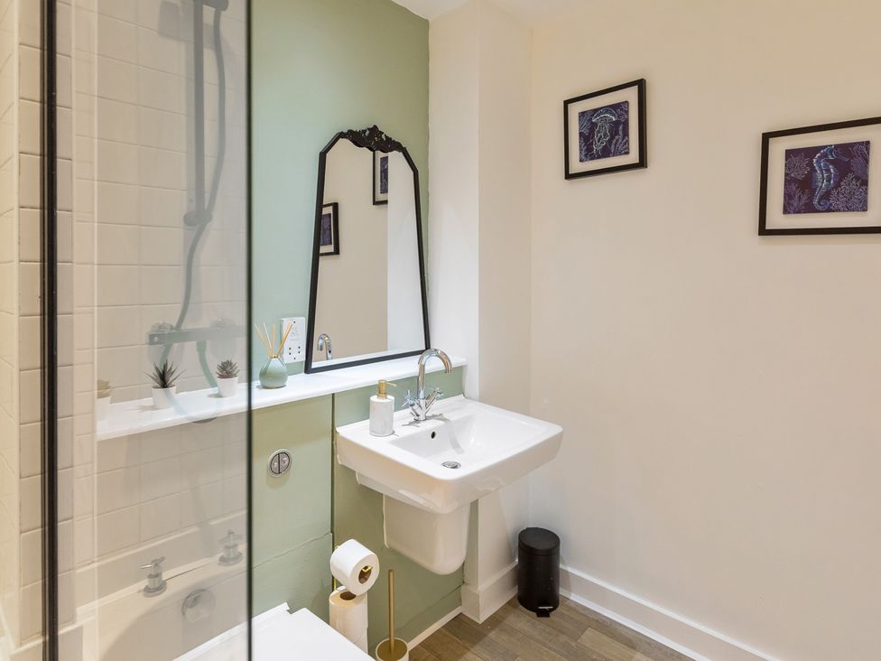 A bathroom with a shower and sink at 11 Radclyffe Mews in Salford