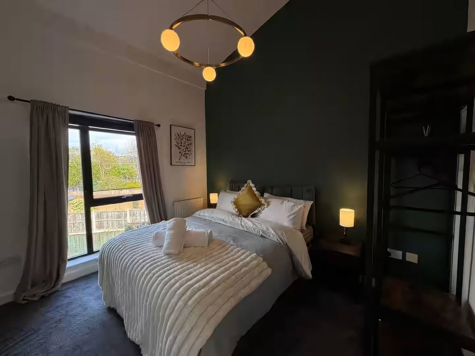 A bedroom with a bed and window at 11 Radclyffe Mews in Salford