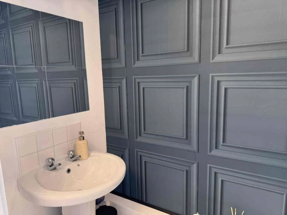 A bathroom with a sink and mirror at 11 Radclyffe Mews, Salford