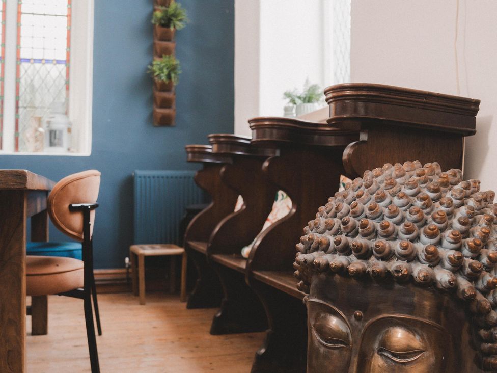A dining room with a table and chairs at Chapel of Arts in Criccieth