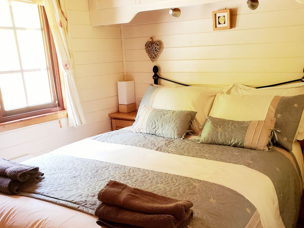 A bedroom with bed and bedside table at River Lodge Lynbridge near Lynmouth