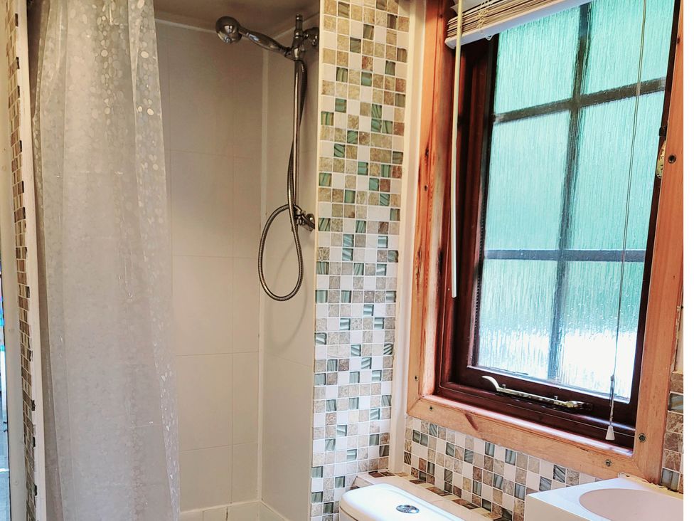 A bathroom with a shower and toilet at River Lodge in Lynbridge near Lynmouth