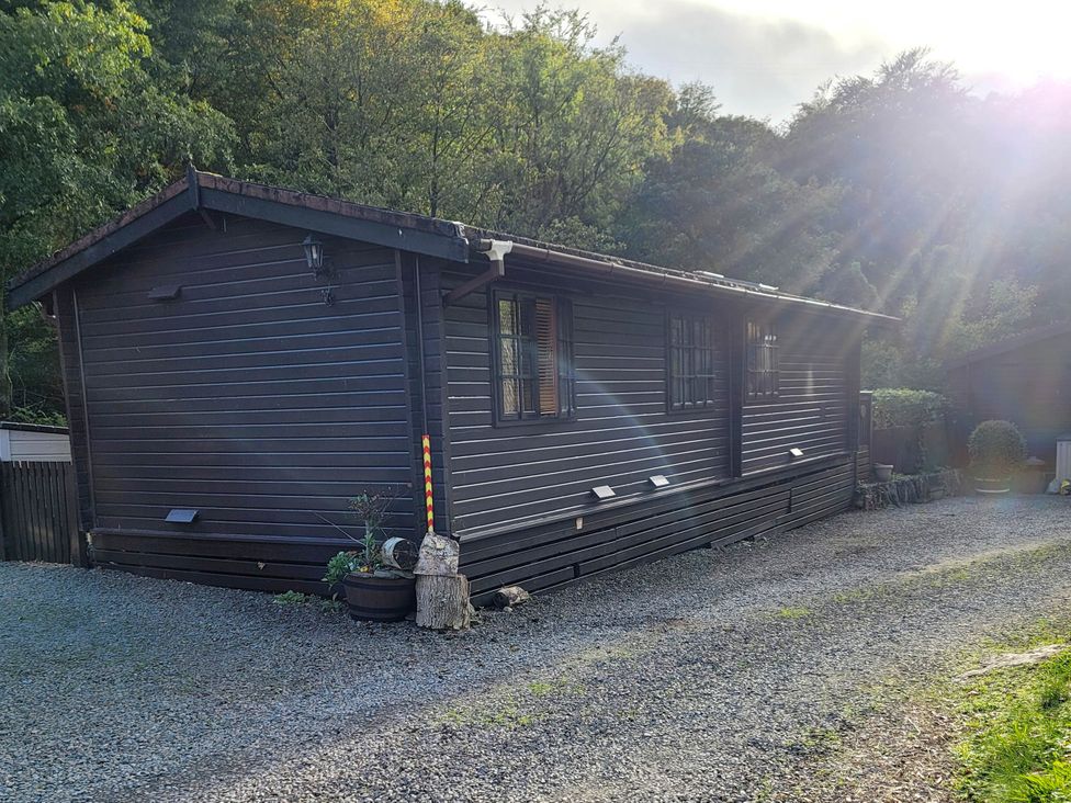 A house with windows and plants at River Lodge in Lynbridge near Lynmouth
