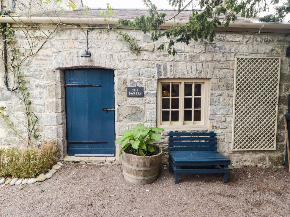 An entrance with a blue door and sign at The Bakery Hotel Room in Gileston near St Athan