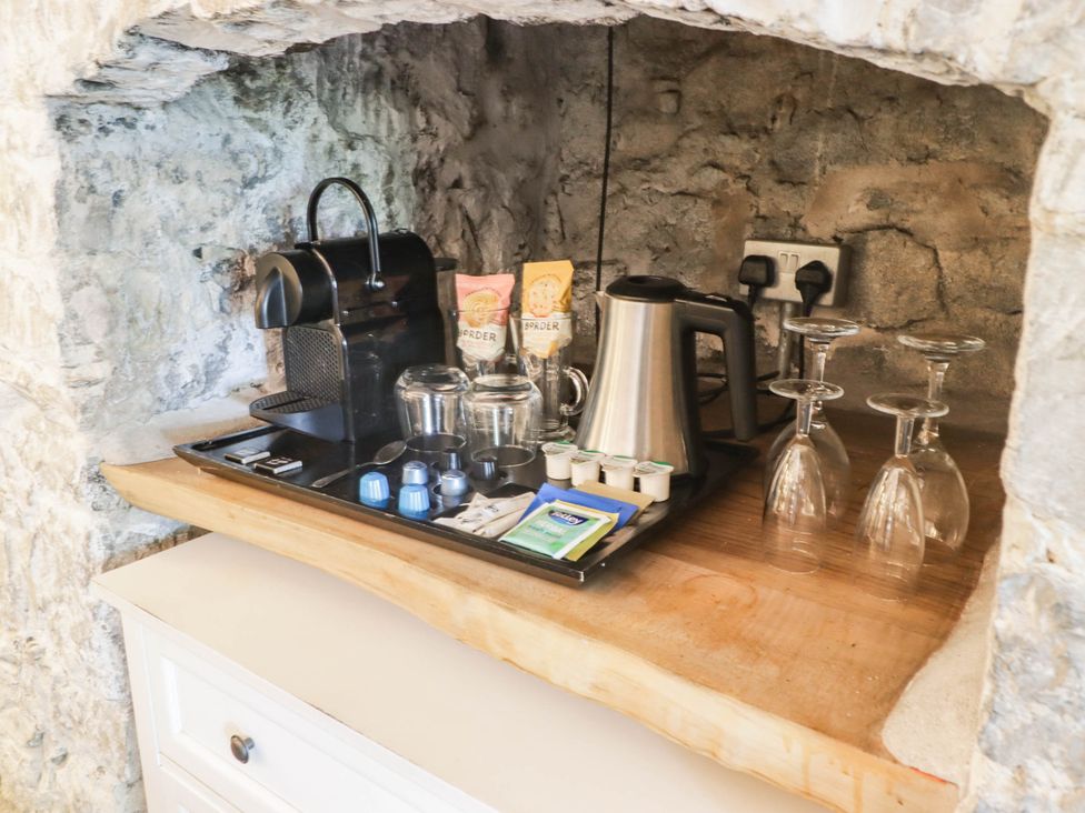 A kitchen counter with a Nespresso machine and coffee accessories at The Bakery Hotel Room in Gileston near St Athan