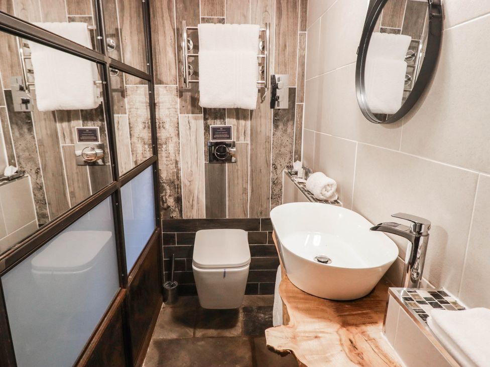 A bathroom with a sink and toilet at The Bakery Hotel Room in Gileston near St Athan
