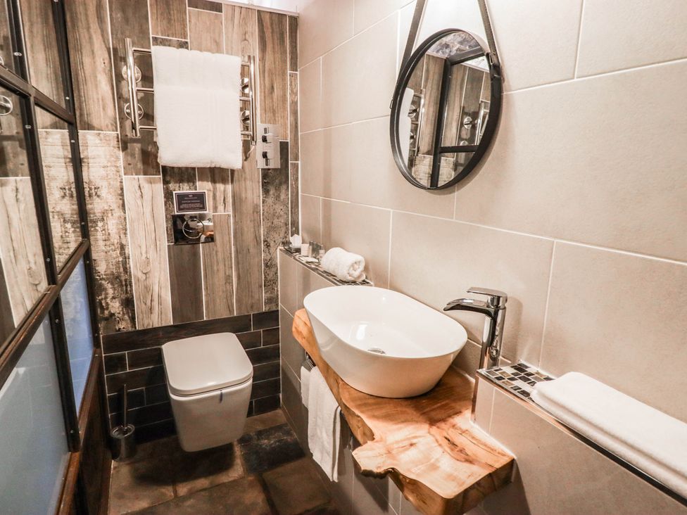 A bathroom featuring a sink and toilet at The Bakery Hotel Room in Gileston near St Athan