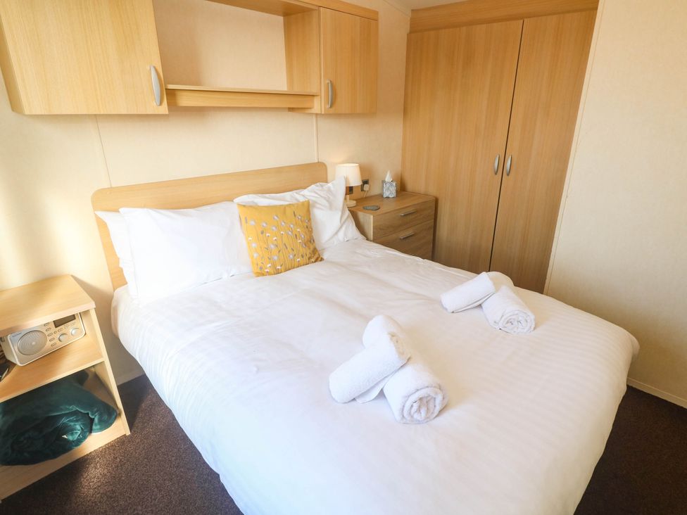 A bedroom with a bed and wardrobe at No.73 Sennen Cove