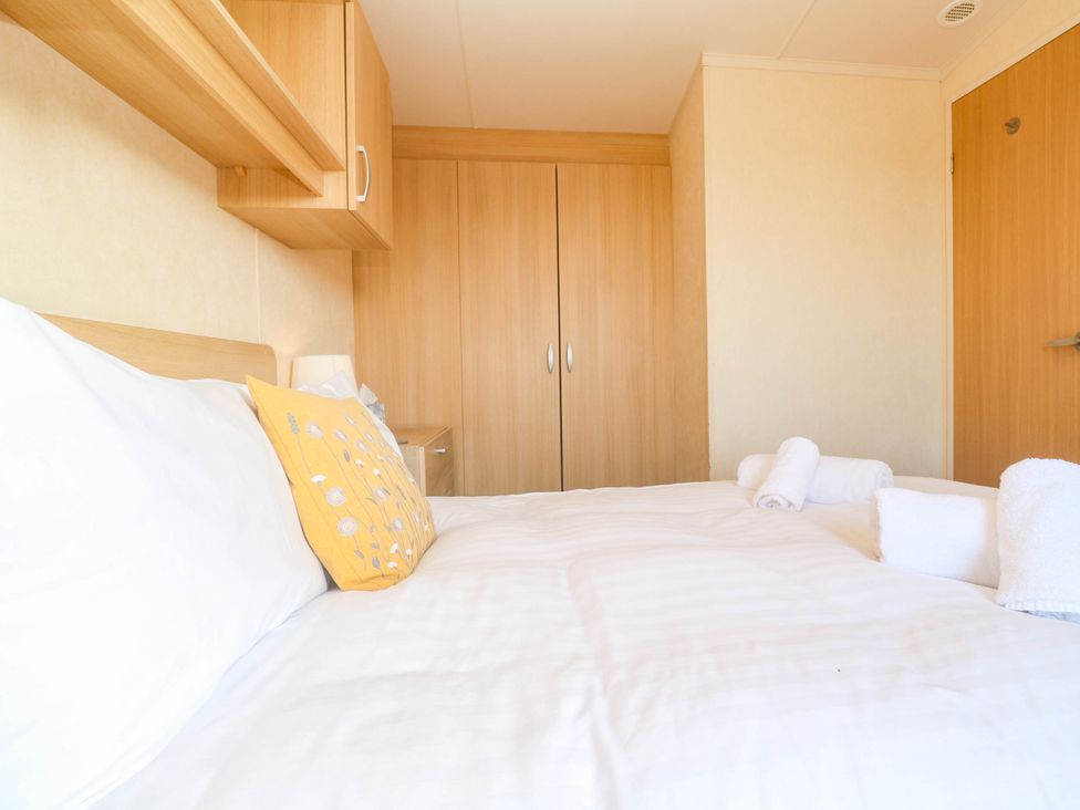 A bedroom with a bed and wardrobe at No.73 Sennen Cove