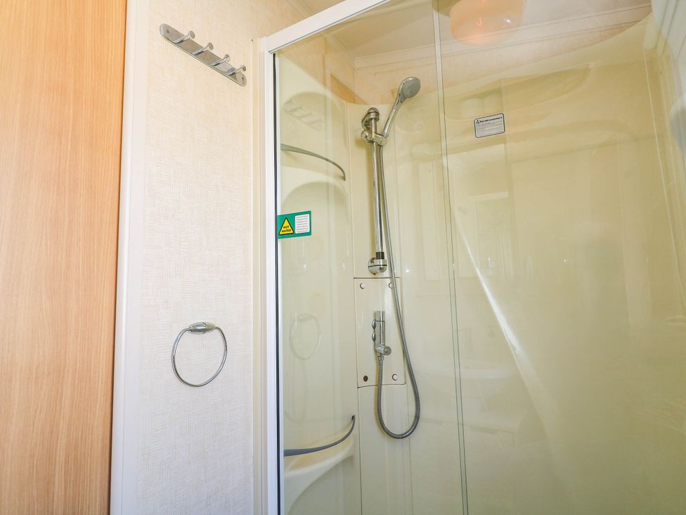 A shower with glass door in No.73 Sennen Cove