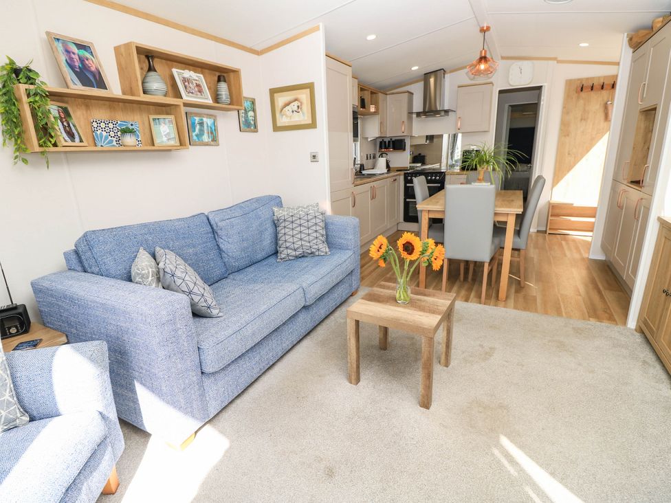 A living room with a sofa and table at 216 Solent Breezes in Southampton