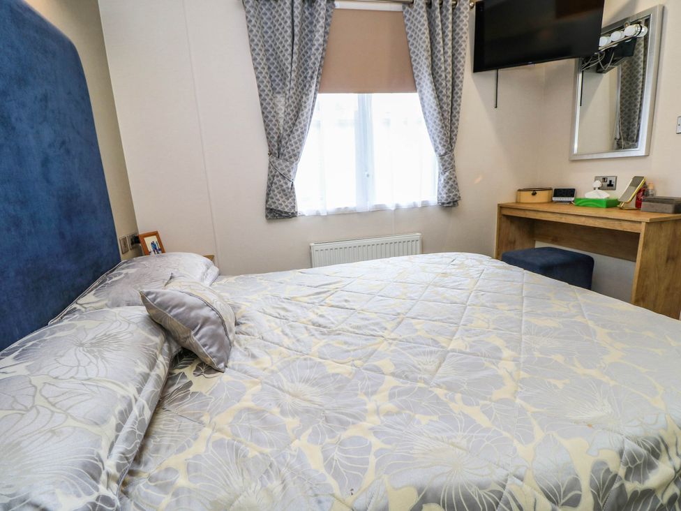 A bedroom with a bed and a desk at 216 Solent Breezes in Southampton