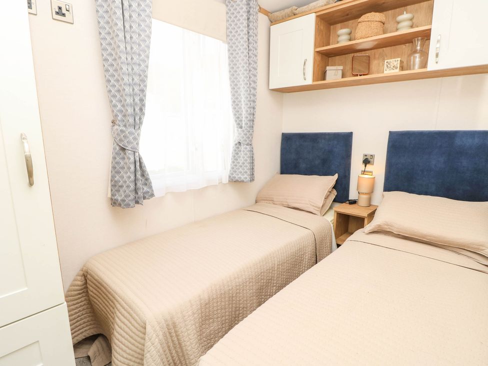 A bedroom with two beds and a nightstand at 216 Solent Breezes Southampton