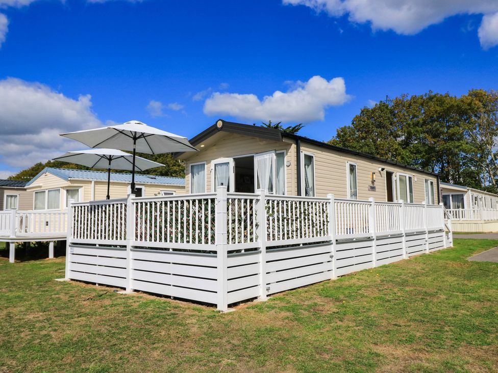 A house with a deck and parasol at 216 Solent Breezes Southampton
