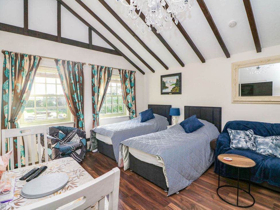 A bedroom with two beds and a seating area at Kate’s in Daingean