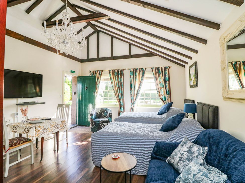 A bedroom with two beds and a television at Kate’s in Daingean