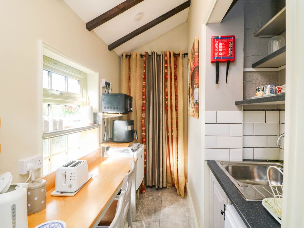 A kitchen with a counter, toaster, kettle, and sink at Kate’s in Daingean