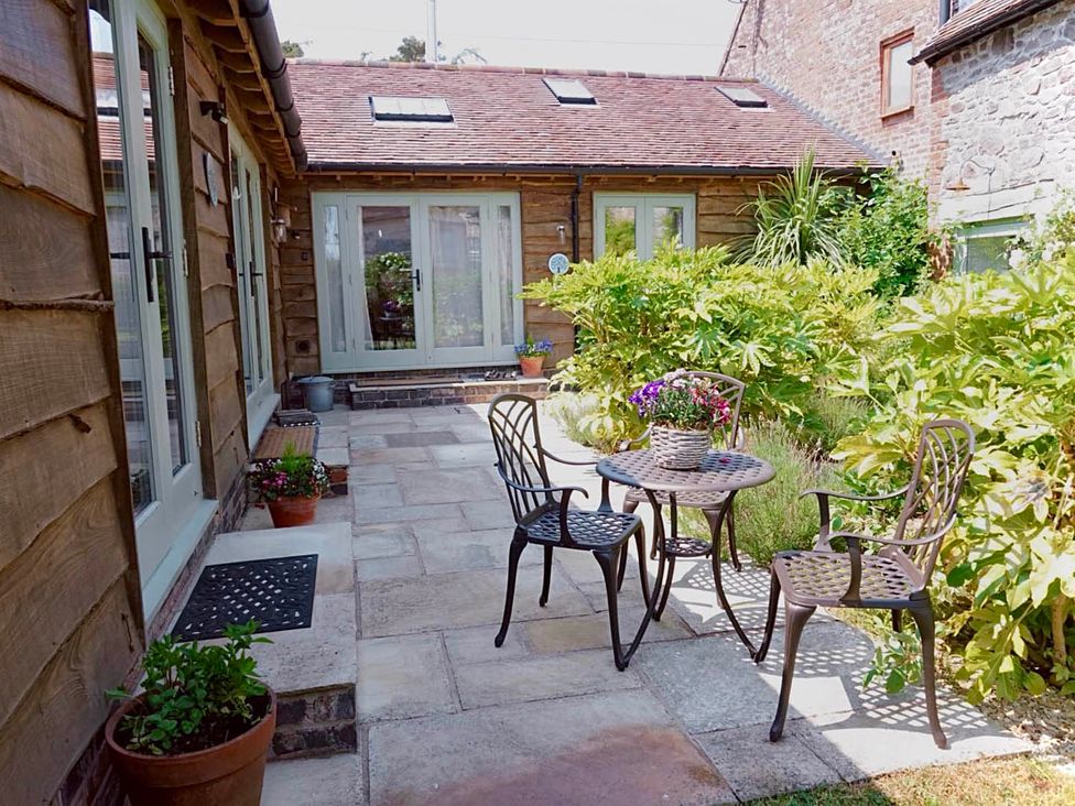 A garden area with a table and chairs at Nest Holiday Hideaway Wren Cottage Stunning Area Picklescott near Church Stretton