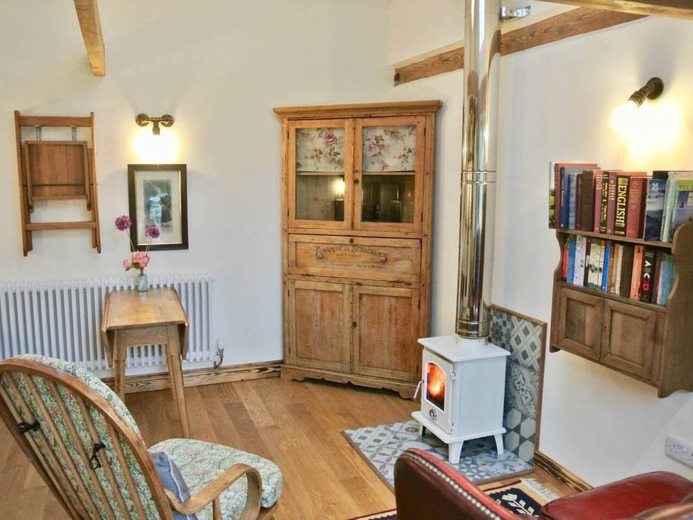 A living room with a table and chairs at Nest Holiday Hideaway Wren Cottage Stunning Area Picklescott near Church Stretton