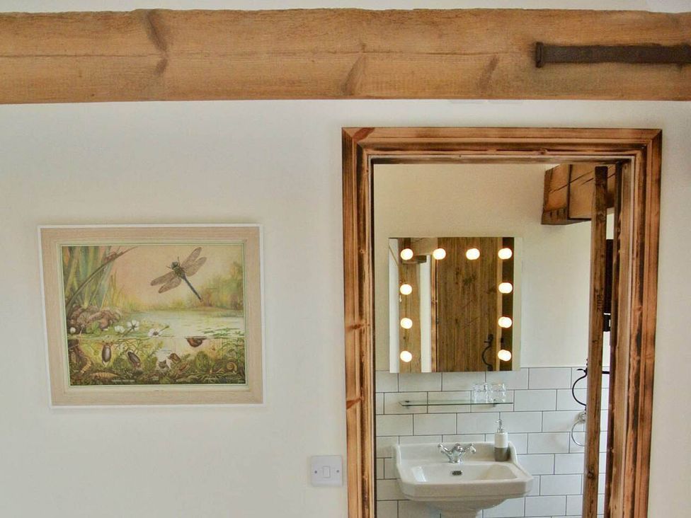 A bathroom with a sink and mirror at Nest Holiday Hideaway Wren Cottage Stunning Area, Picklescott near Church Stretton