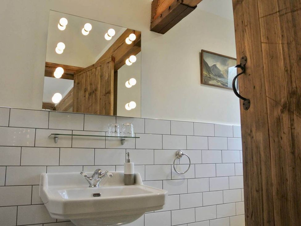 A bathroom with a sink and mirror at Nest Holiday Hideaway Wren Cottage Stunning Area Picklescott near Church Stretton