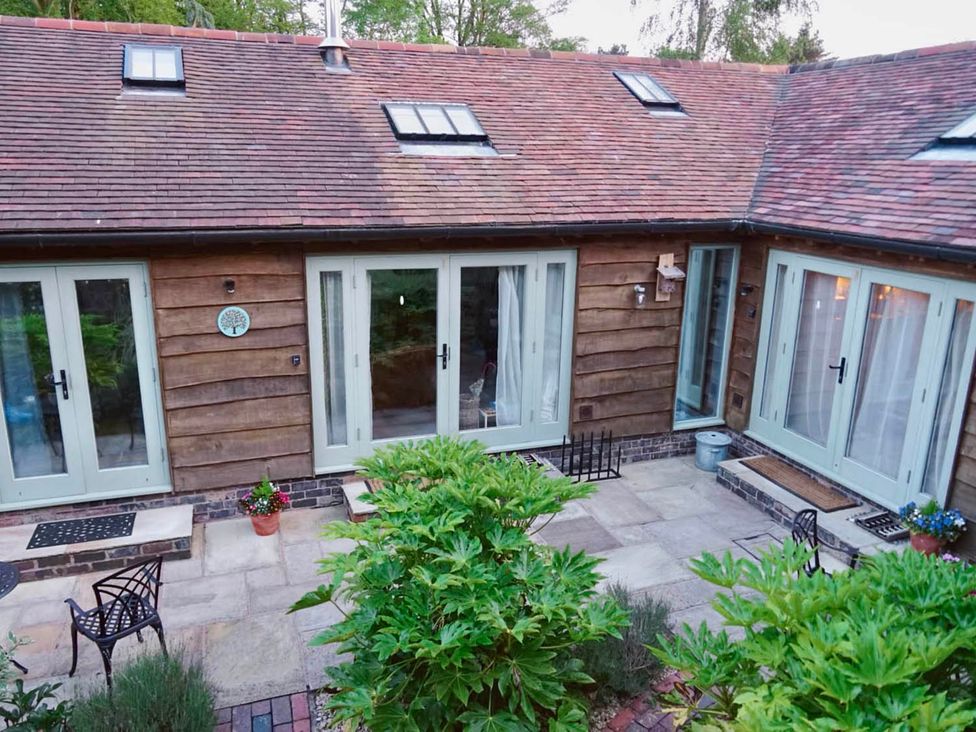 An outdoor area with doors and windows at Nest Holiday Hideaway Wren Cottage Stunning Area Picklescott near Church Stretton