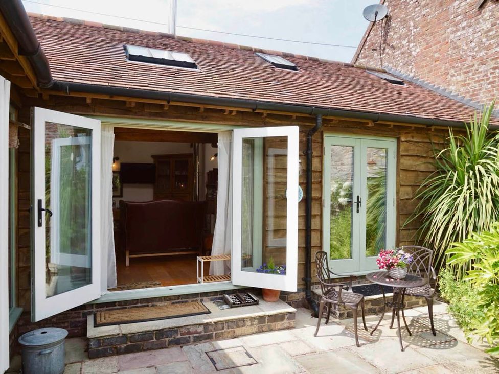 An outdoor area with chairs and a table at Nest Holiday Hideaway Wren Cottage Stunning Area Picklescott near Church Stretton