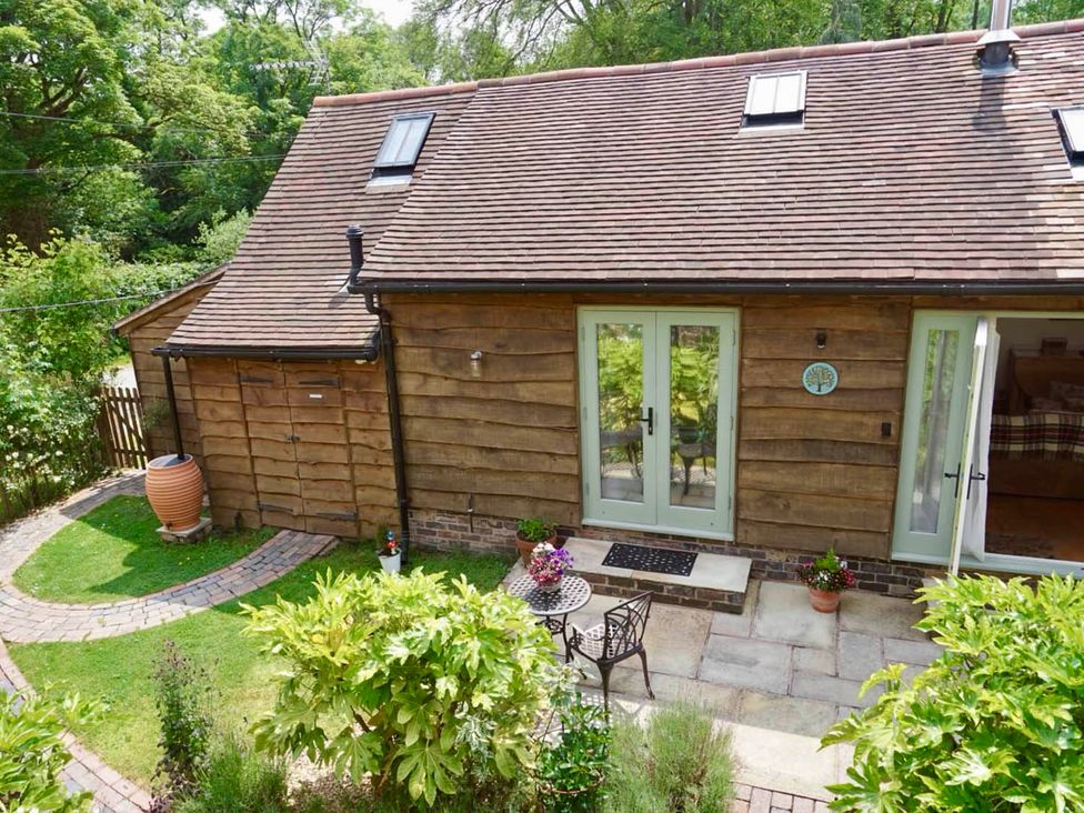 A garden with a cottage and seating area at Nest Holiday Hideaway Wren Cottage Stunning Area Picklescott near Church Stretton