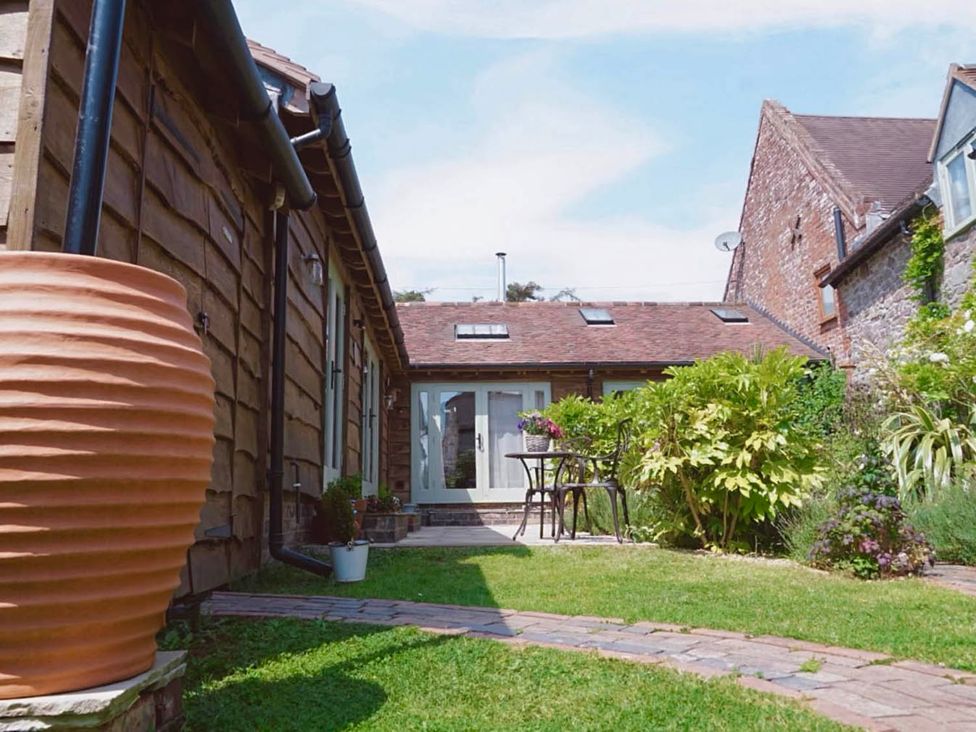 A garden with a table and chairs at Nest Holiday Hideaway Wren Cottage Stunning Area, Picklescott near Church Stretton