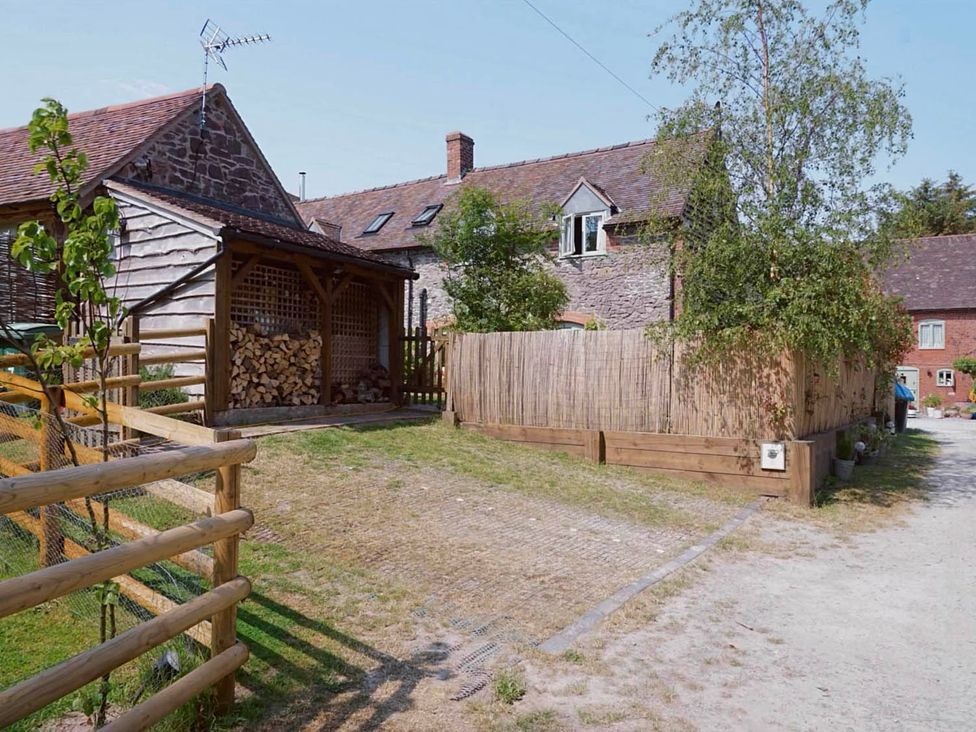 An outdoor area with a wooden shed and firewood at Nest Holiday Hideaway Wren Cottage Stunning Area near Picklescott